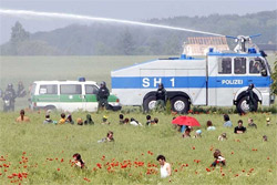 Protesters and water cannon in a field